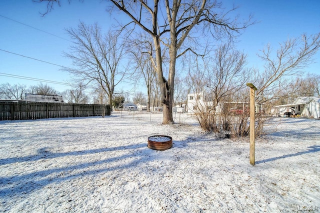 snowy yard with fence