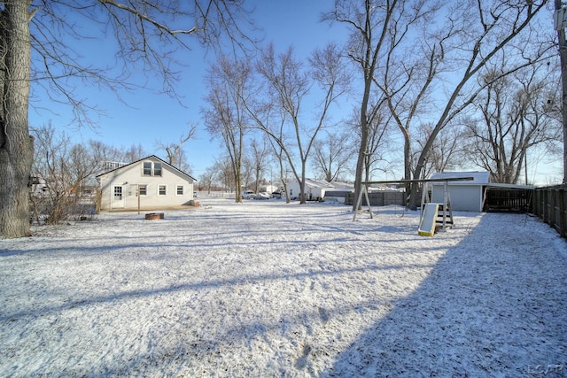 yard covered in snow with fence