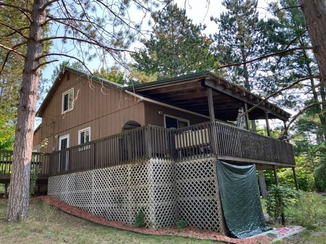 rear view of property featuring a deck