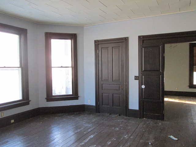 interior space featuring baseboards and wood-type flooring