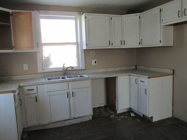 kitchen with a sink, open shelves, white cabinets, and dark wood finished floors