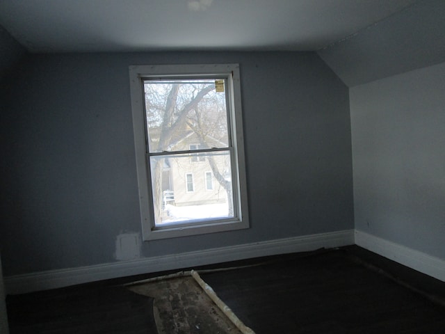 bonus room with baseboards and vaulted ceiling