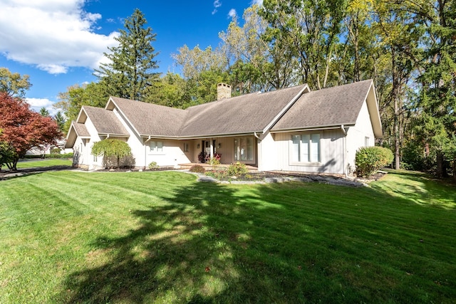 ranch-style house with a front yard and a chimney