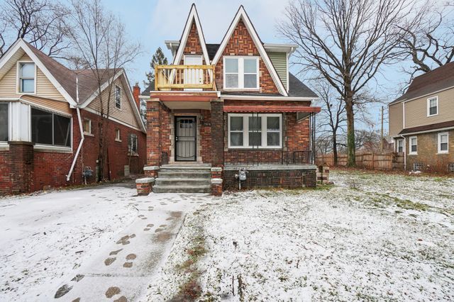 english style home featuring brick siding