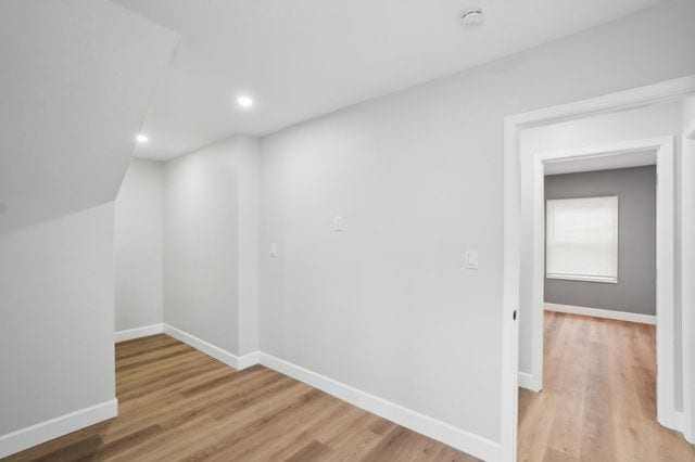 bonus room featuring recessed lighting, wood finished floors, and baseboards