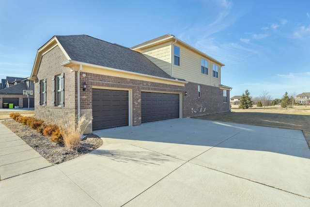 view of home's exterior with brick siding, driveway, a shingled roof, and an attached garage