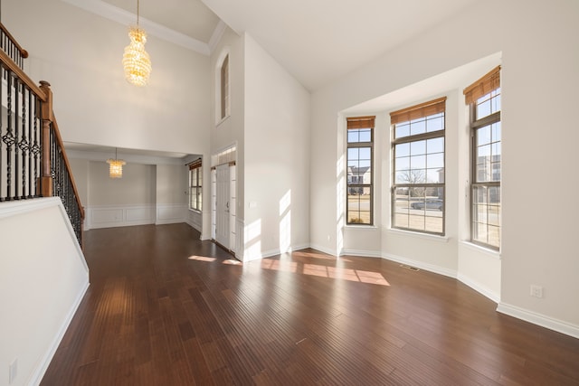 entryway with visible vents, baseboards, stairway, an inviting chandelier, and wood finished floors