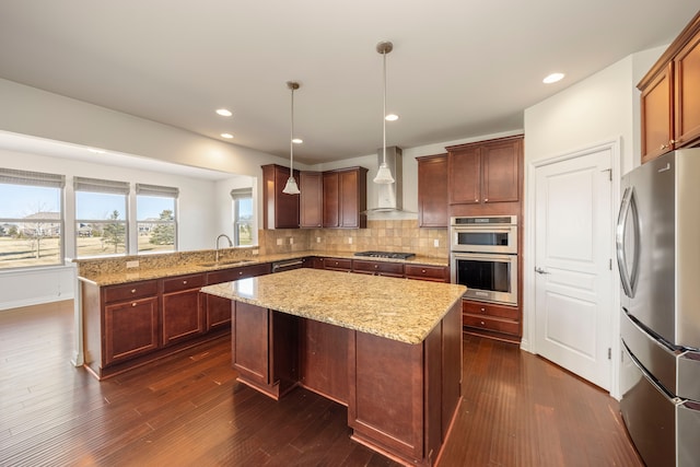 kitchen with backsplash, dark wood finished floors, stainless steel appliances, wall chimney exhaust hood, and a sink