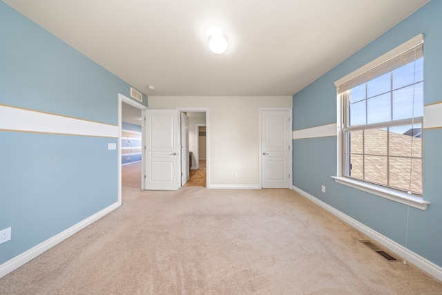 unfurnished bedroom with visible vents, baseboards, and carpet floors