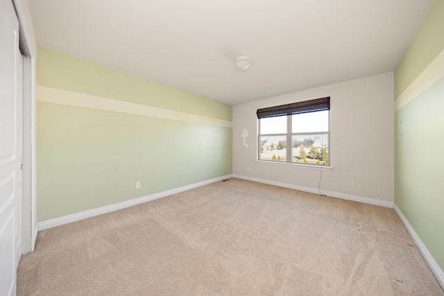 carpeted empty room with baseboards