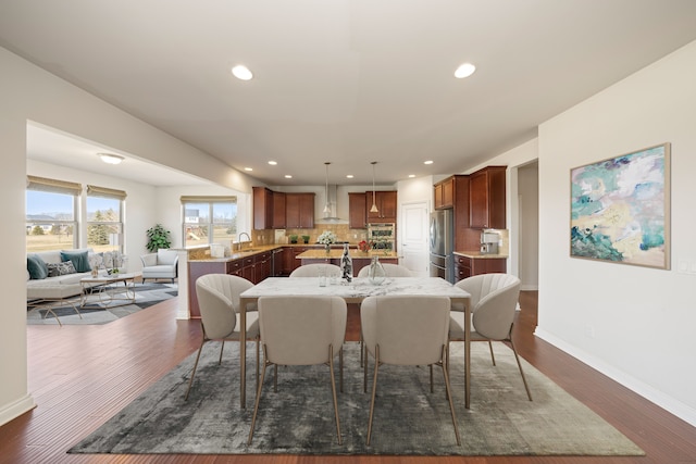 dining area with recessed lighting, dark wood-type flooring, and baseboards