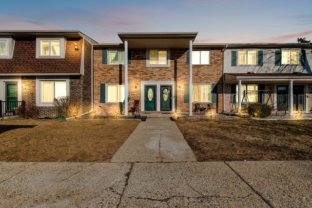 townhome / multi-family property with brick siding