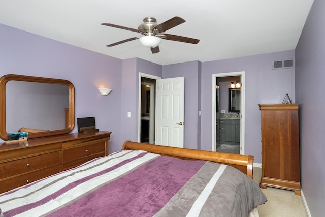 bedroom with carpet floors, ceiling fan, ensuite bathroom, baseboards, and visible vents