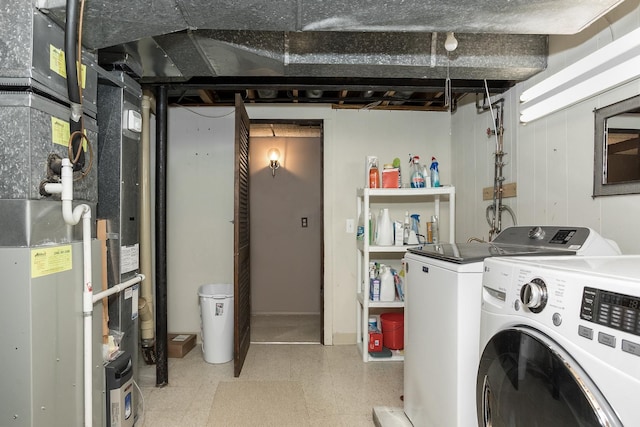 washroom featuring tile patterned floors, separate washer and dryer, heating unit, and laundry area