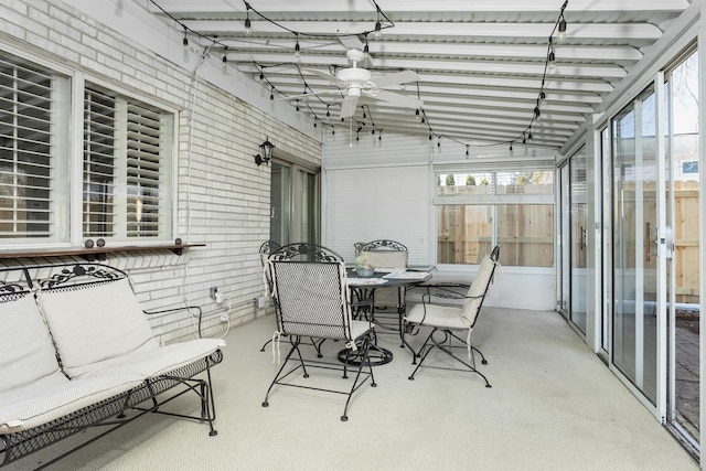sunroom / solarium with a healthy amount of sunlight, ceiling fan, and outdoor dining area