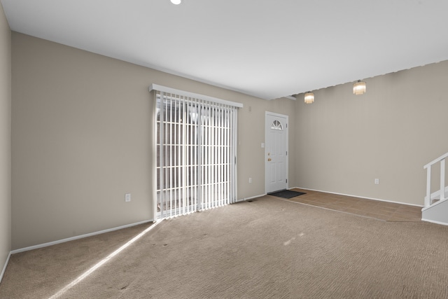 interior space with stairway, carpet flooring, and baseboards