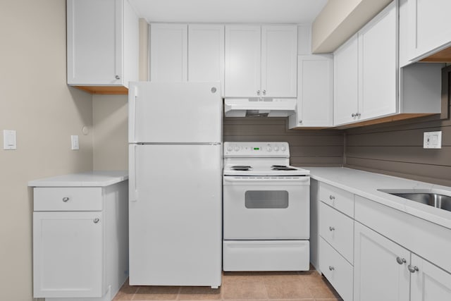 kitchen with white cabinetry, white appliances, light countertops, and under cabinet range hood