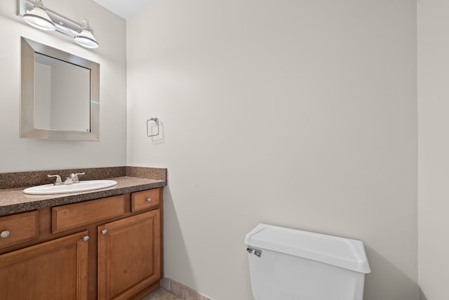 bathroom featuring toilet and vanity