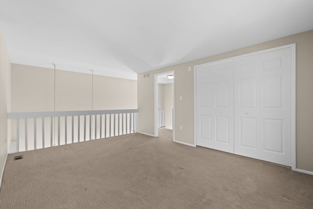 empty room with visible vents, carpet flooring, and baseboards