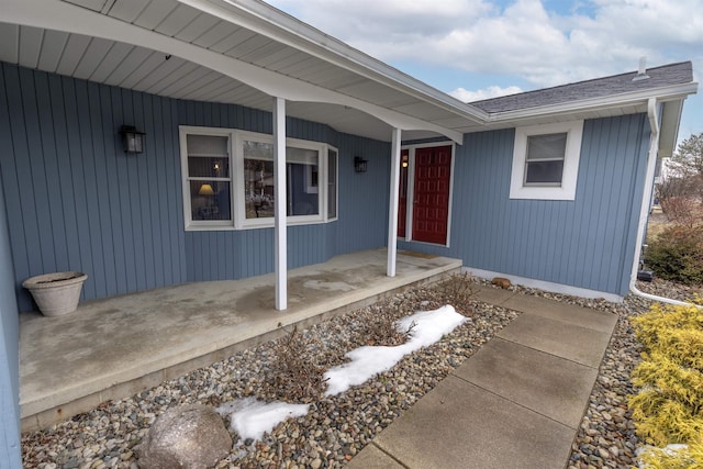 view of exterior entry with covered porch