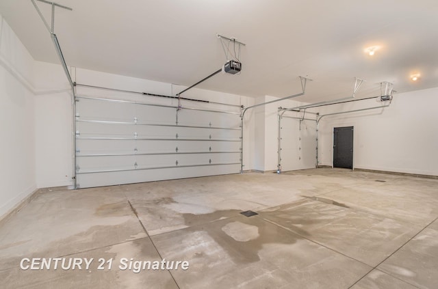 garage featuring a garage door opener and baseboards