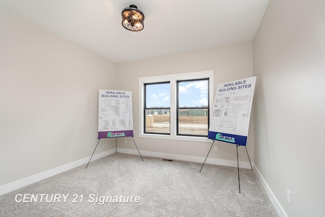 interior space with baseboards and carpet floors