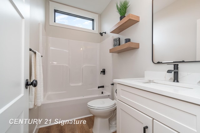 full bath with vanity, bathing tub / shower combination, toilet, and wood finished floors