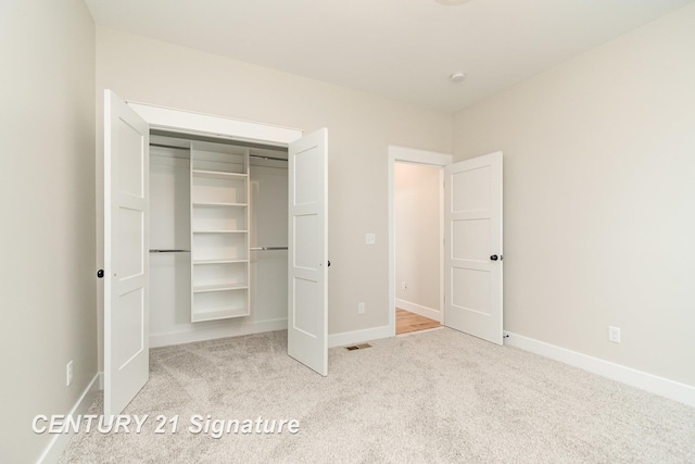 2289 Holly Ridge Ln, Bay City, MI 48706 - unfurnished bedroom featuring carpet floors, a closet, and baseboards