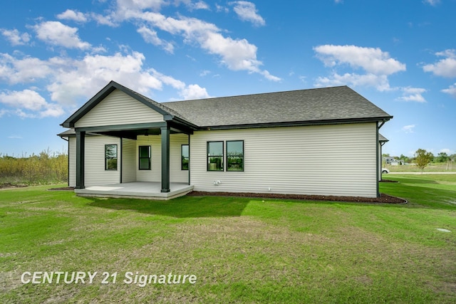 2289 Holly Ridge Ln, Bay City, MI 48706 - back of house featuring a lawn and a shingled roof