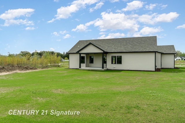 2289 Holly Ridge Ln, Bay City, MI 48706 - view of front of property featuring a front yard, a patio, and roof with shingles