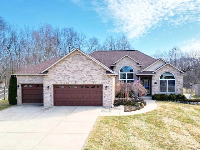 view of front of house with brick siding, a front lawn, concrete driveway, roof with shingles, and a garage