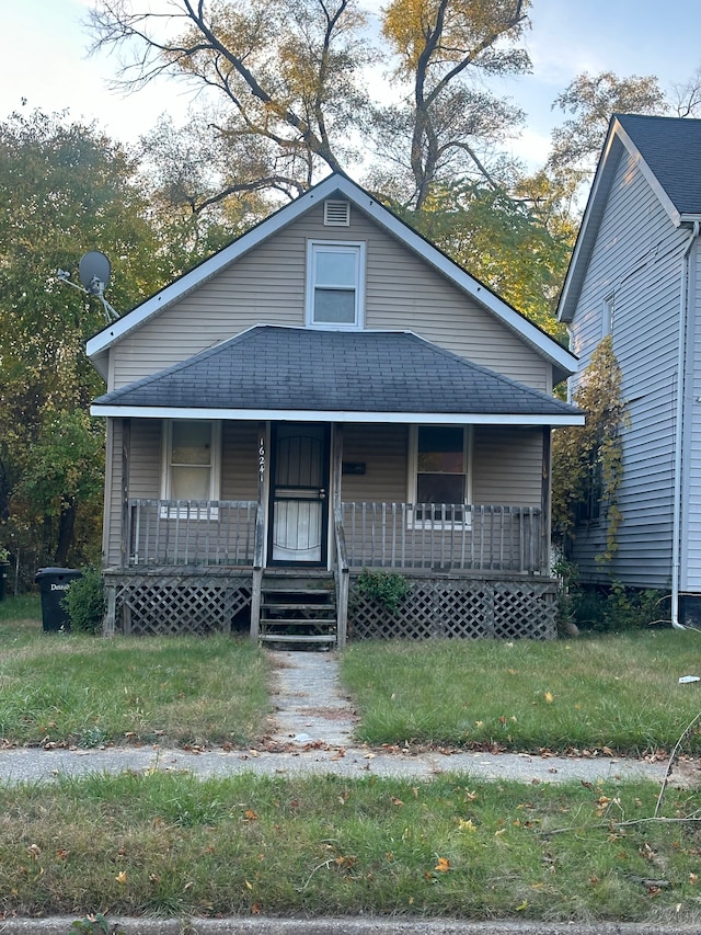 bungalow with roof with shingles and covered porch