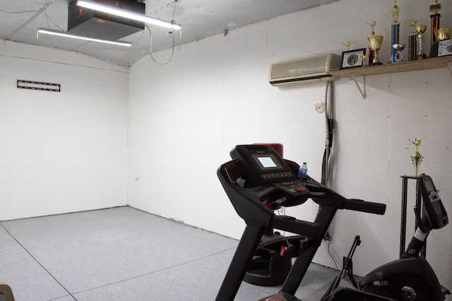 exercise area featuring a wall mounted air conditioner