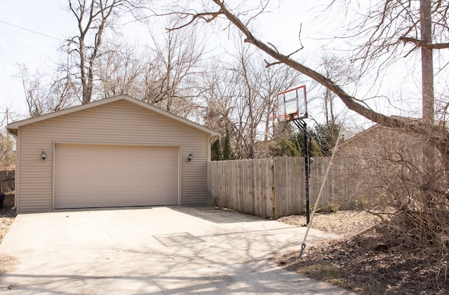 detached garage featuring fence