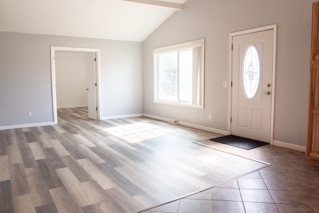 entrance foyer with visible vents, wood finished floors, baseboards, and vaulted ceiling