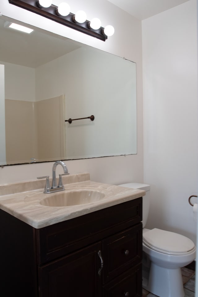 bathroom featuring toilet and vanity