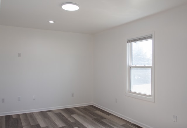 empty room with recessed lighting, baseboards, and wood finished floors