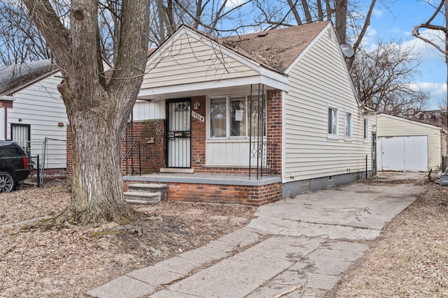 view of front of property with brick siding, crawl space, a porch, and fence