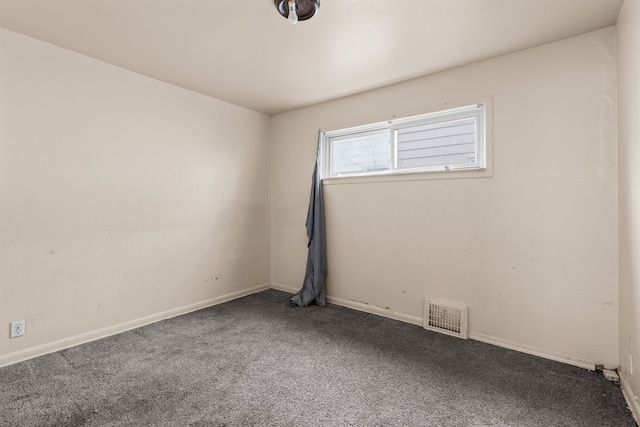 carpeted empty room featuring visible vents and baseboards