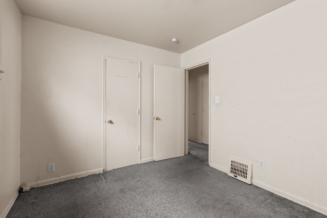 unfurnished bedroom featuring visible vents and carpet floors