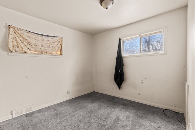 spare room with visible vents, baseboards, and carpet flooring