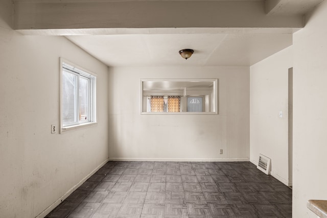 unfurnished room with visible vents and baseboards