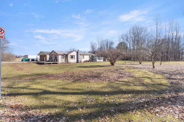 view of front of house with a deck and a front yard