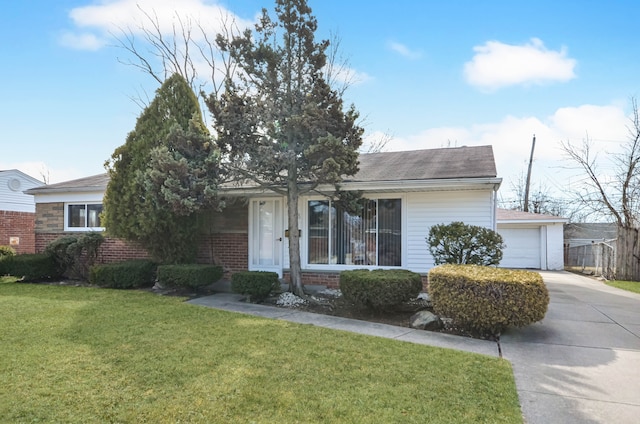 view of front facade with a front lawn, roof with shingles, concrete driveway, a garage, and brick siding