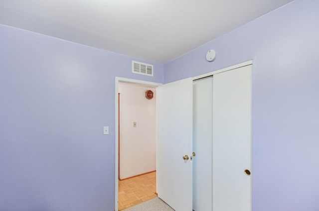 bedroom with visible vents and a closet