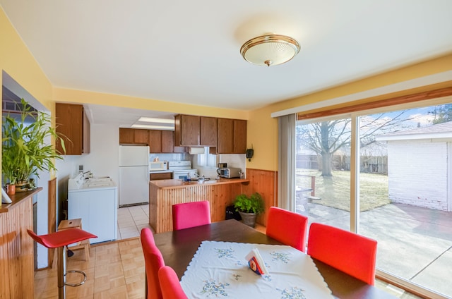 dining room featuring wainscoting and washer / clothes dryer