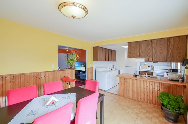 dining room featuring wainscoting and washer and dryer