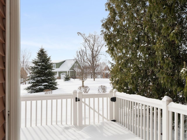 snow covered deck with a gate