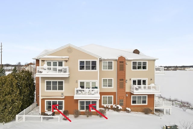 snow covered building with fence