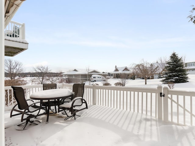 snow covered deck with outdoor dining space